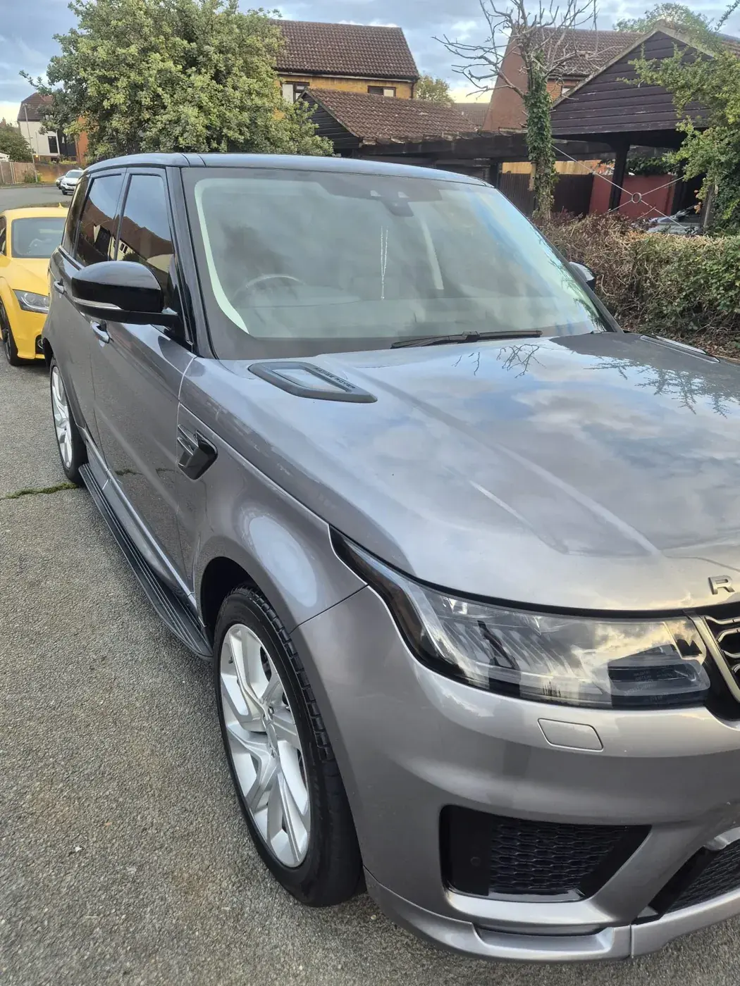 Grey Range Rover Sport parked in the sun with a clean, glossy finish