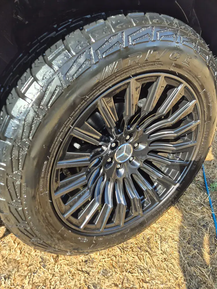 The same Mercedes wheel after cleaning, with the black finish visible
